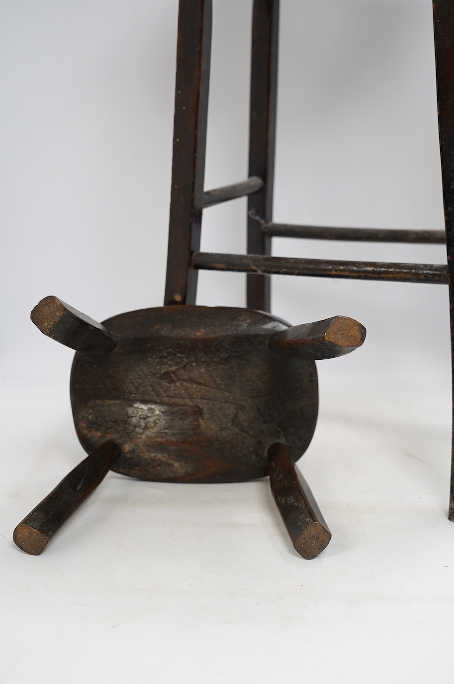 A Victorian elm and beech stool, 54cm high, together with a smaller child's stool. Condition - fair